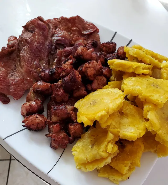 Plate of smoked cecina with mofongo and salsa criolla