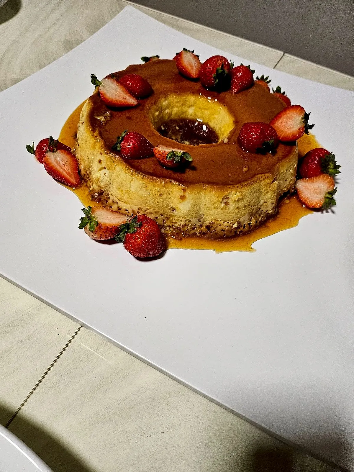 Crema volteada with strawberries at a family dinner