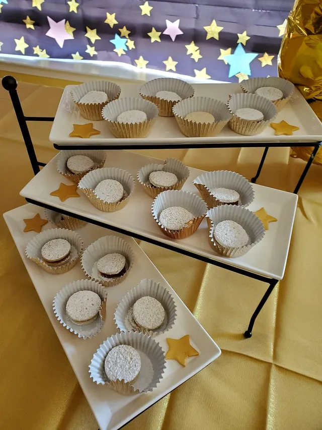 Alfajores in gold cups on a star-themed dessert table