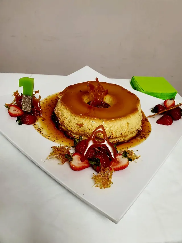 Crema volteada with spun sugar and a number one candle