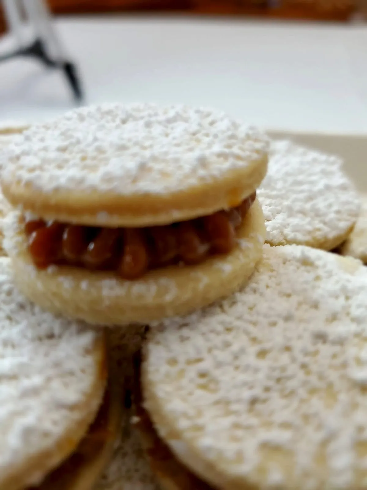 Close-up of an alfajor generously filled with dulce de leche