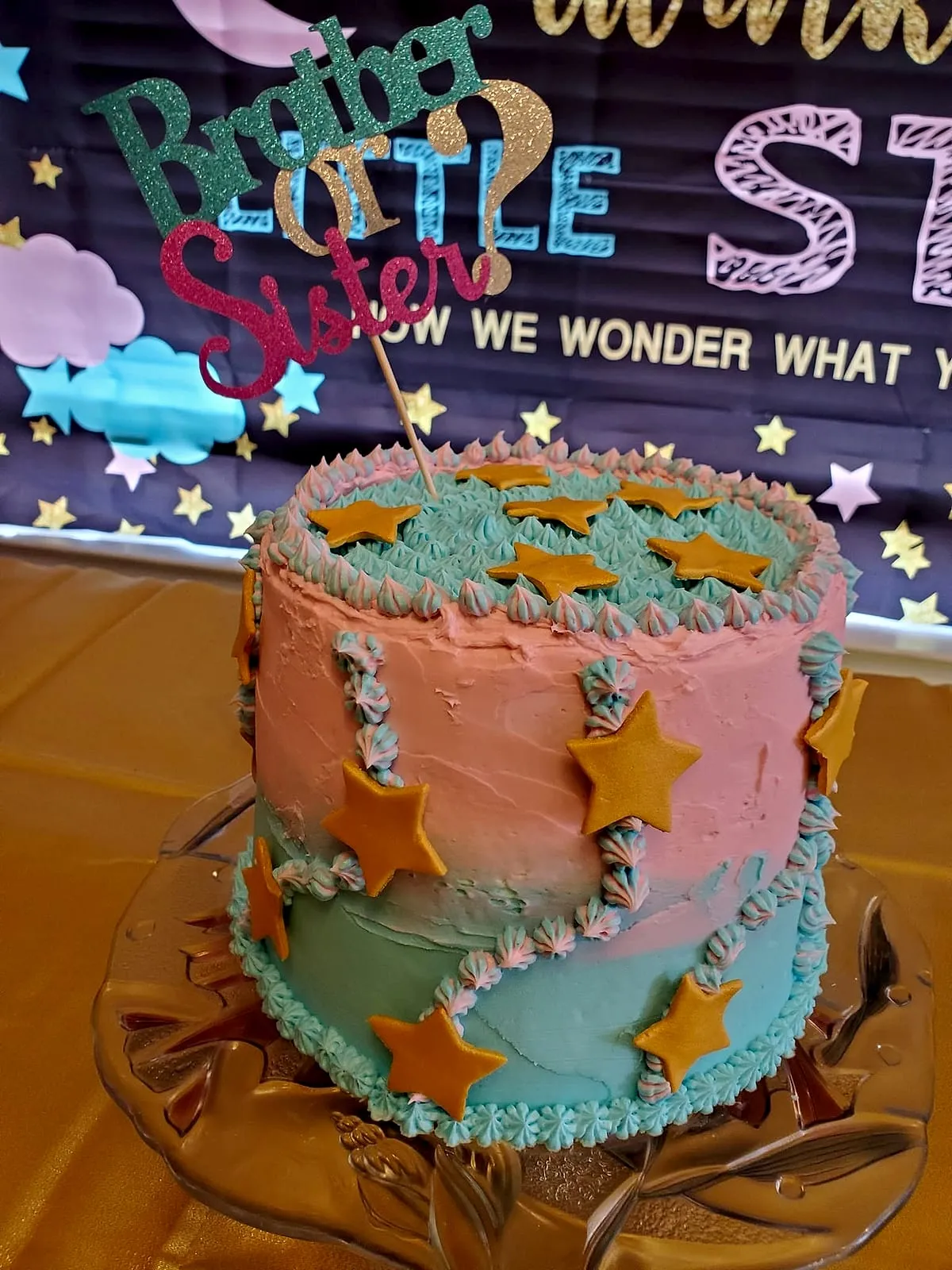 Pink and blue gender-reveal cake with gold stars