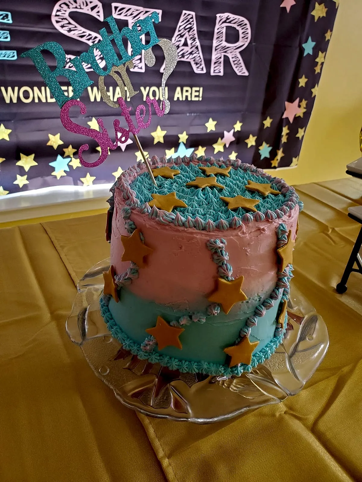 Gender-reveal cake with a brother-or-sister topper