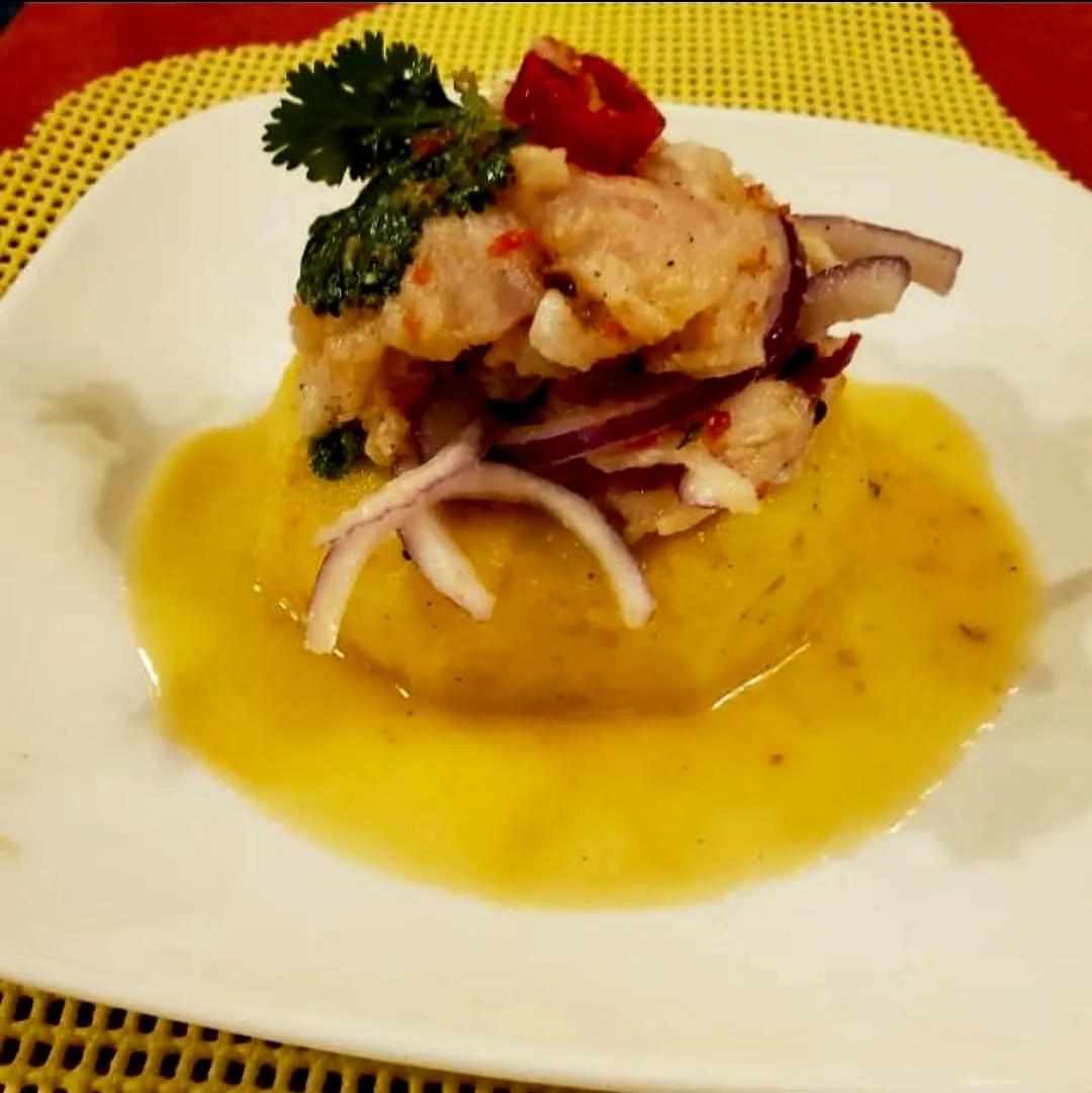 Ceviche served over whipped causa with leche de tigre