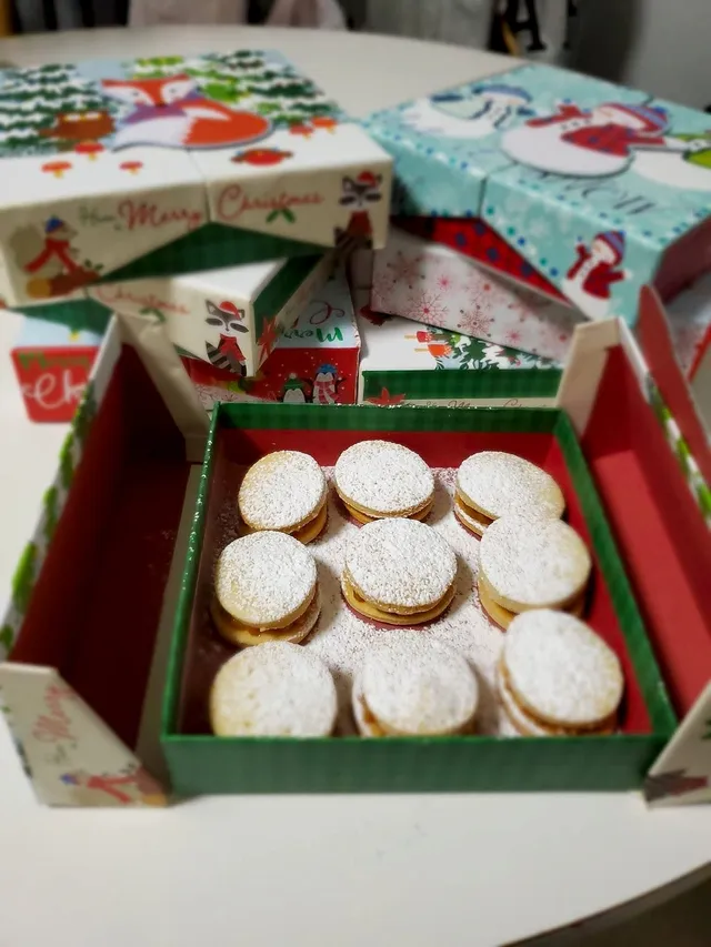 Freshly filled alfajores arranged on a serving plate