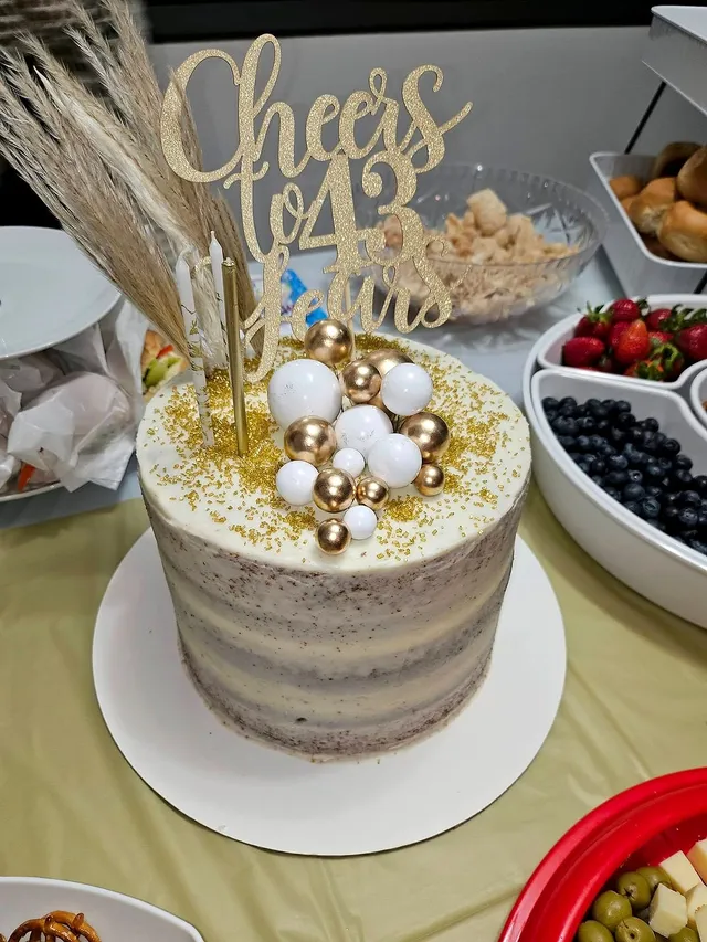 White and gold celebration cake on an event table